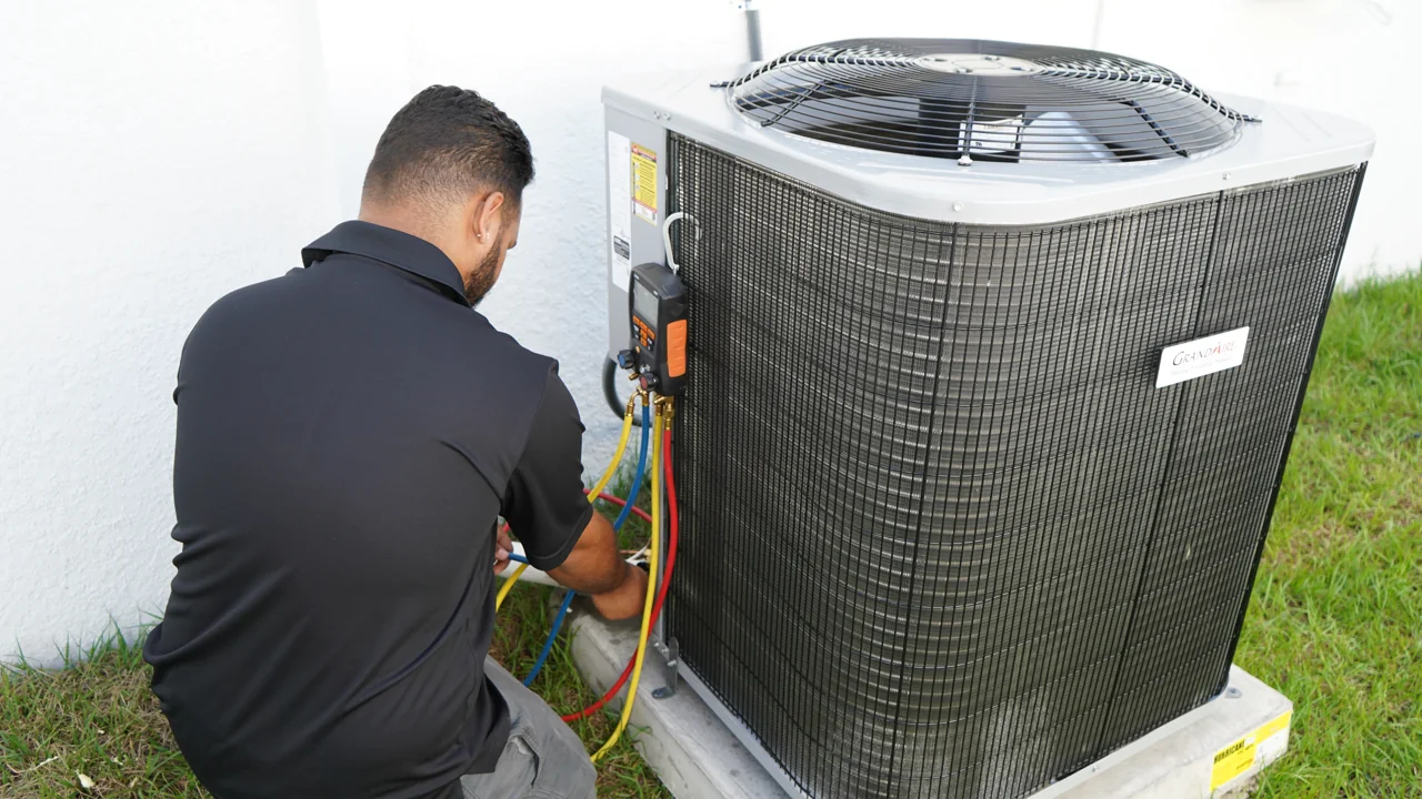 XQS technician working beside an outdoor air conditioning unit