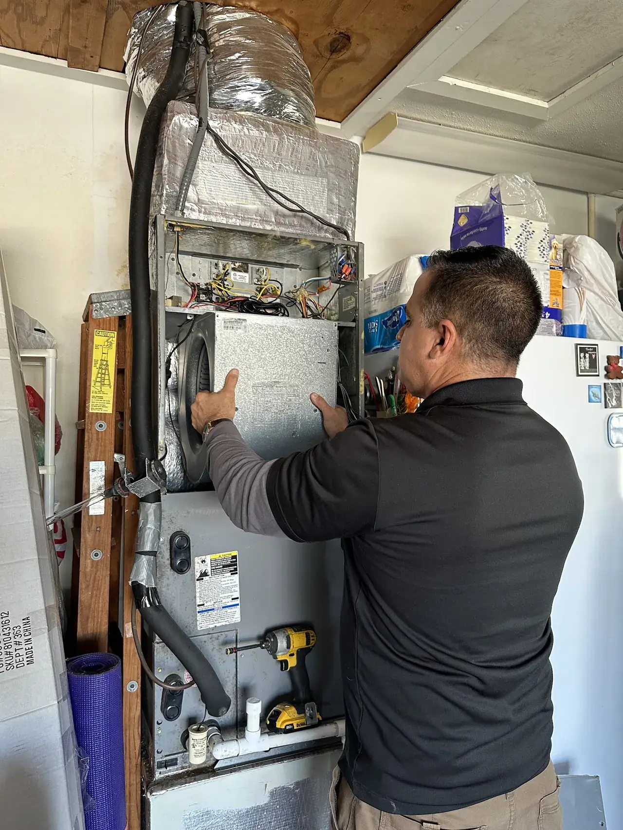 XQS technician servicing an indoor air handler.