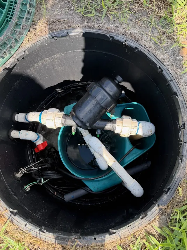 Open septic riser with internal pump and piping.