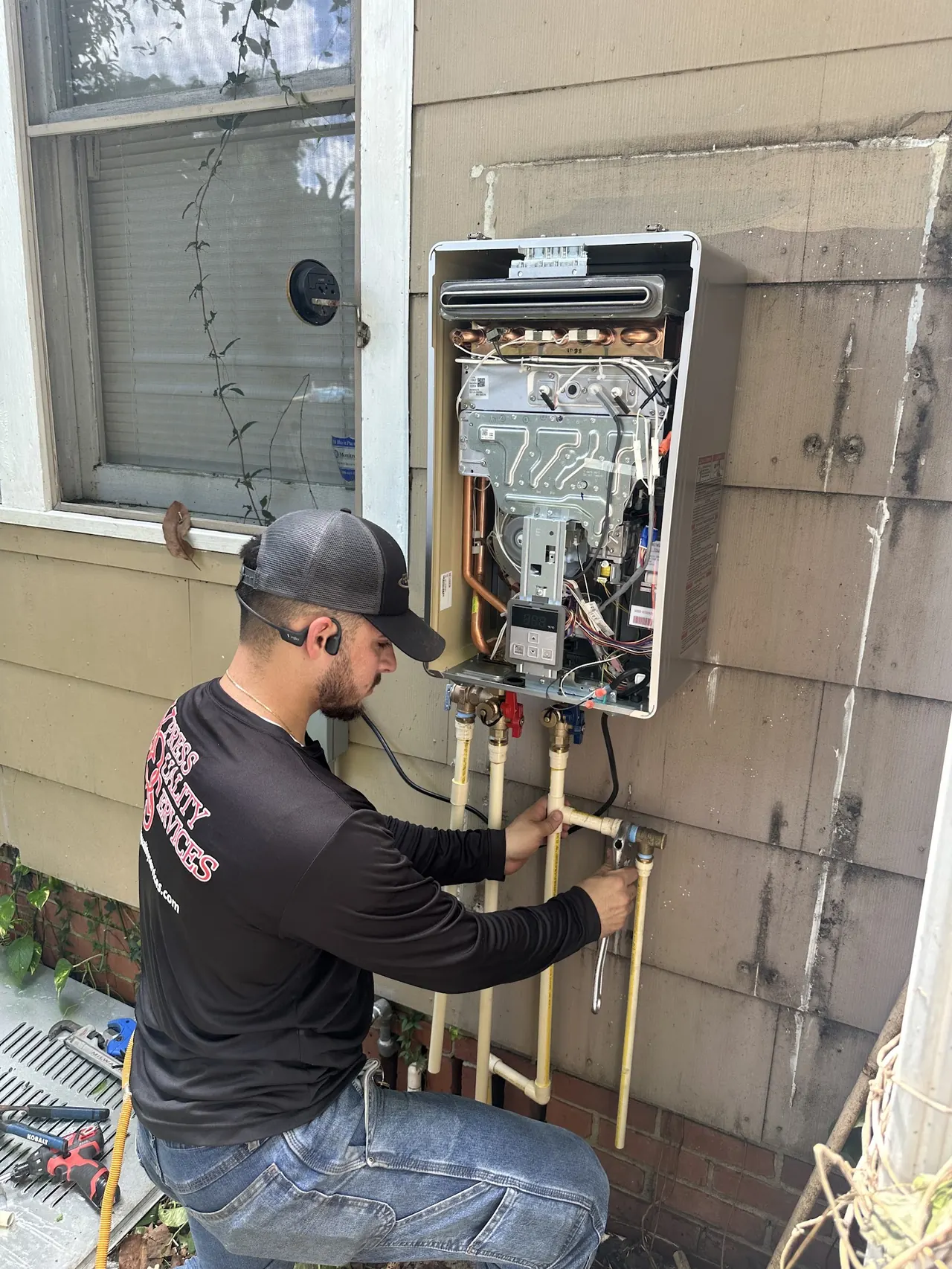 XQS technician installing a tankless water heater