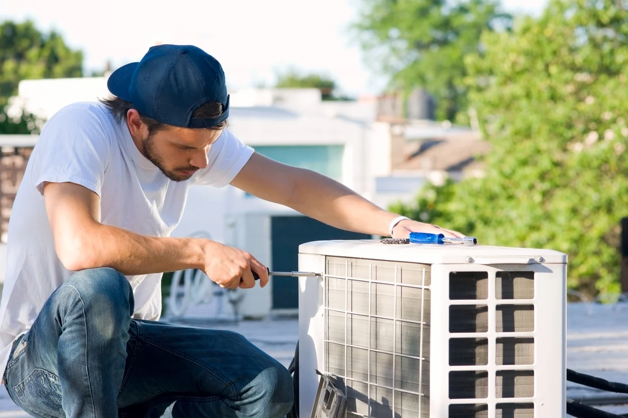 Technician checking an outdoor HVAC unit