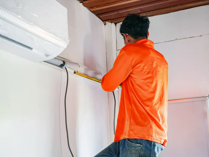 Wall-mounted ductless mini split and line connections