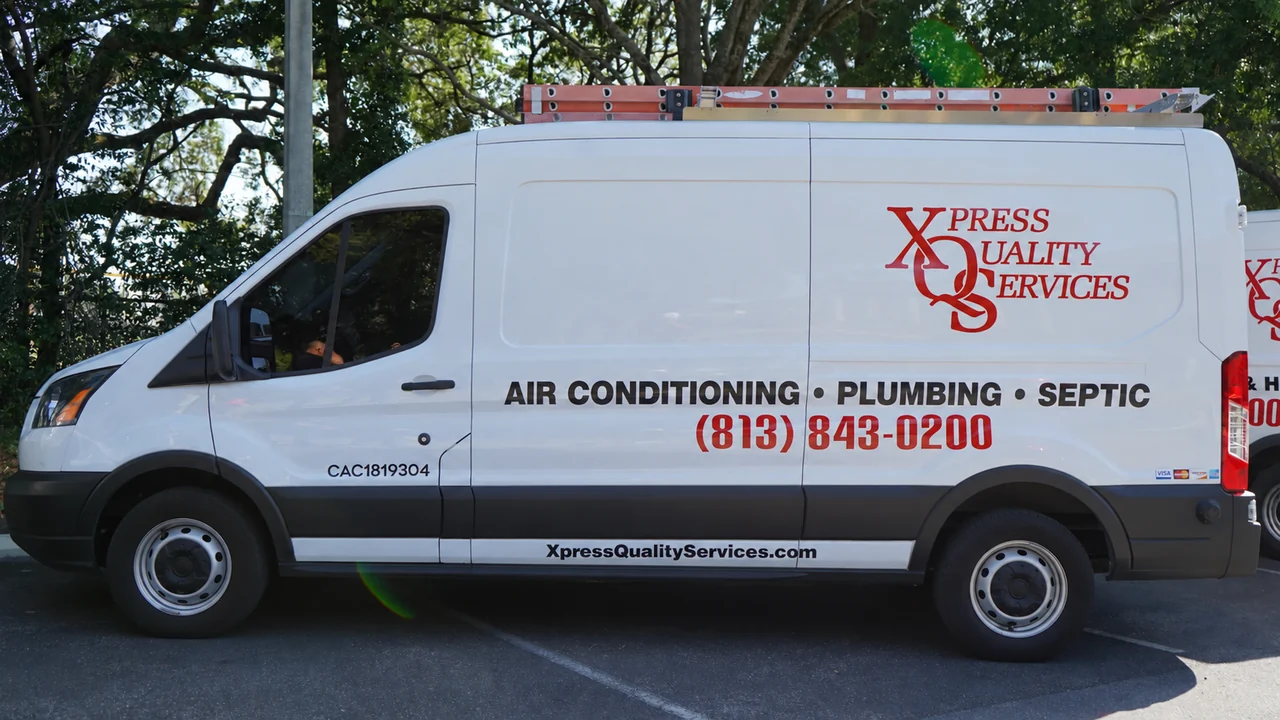 XQS service van with digitally updated air conditioning, plumbing and septic lettering