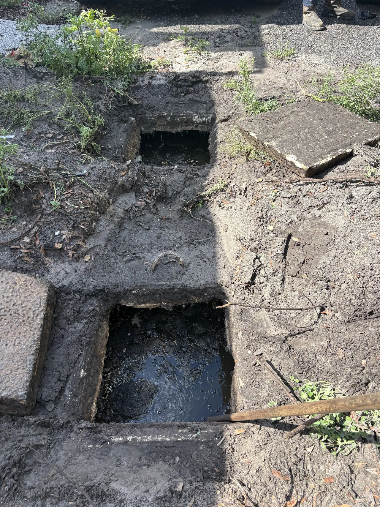 Septic tank access openings documented during a pump-out in Odessa.