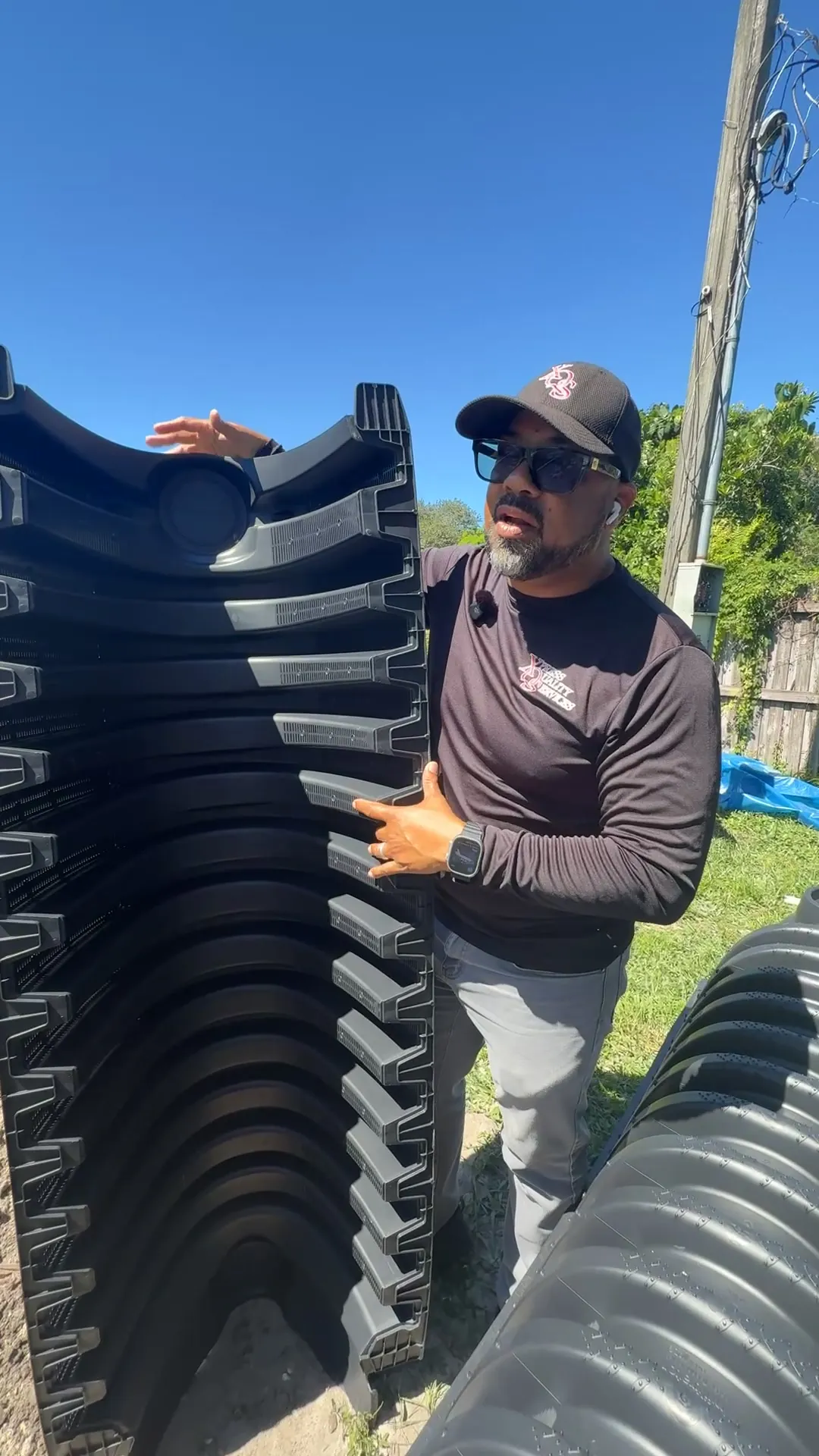 XQS technician beside drain field chambers ready for installation